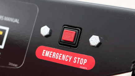 A clearly marked emergency stop button is located on the operators's panel to instantly cut power to the engine.